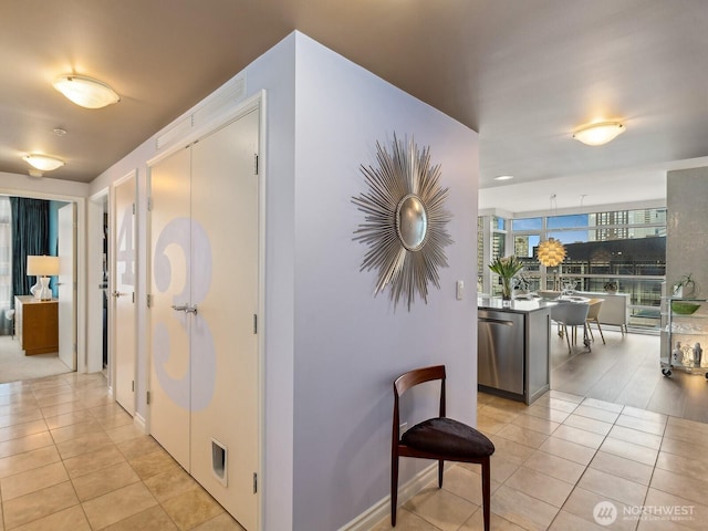 hall with light tile patterned floors