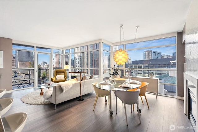 1420 Terry Ave Unit 901, Seattle, WA 98101 - dining room with expansive windows, a notable chandelier, a view of city, and wood finished floors