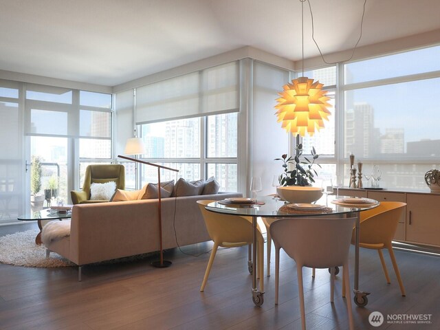 dining space with a city view and wood finished floors