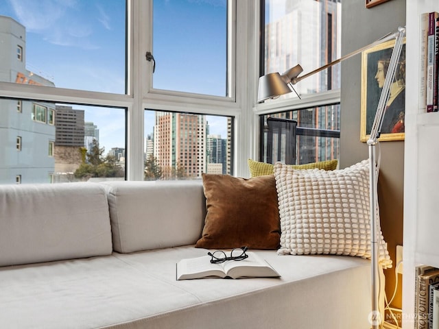 living area featuring a view of city and a high ceiling