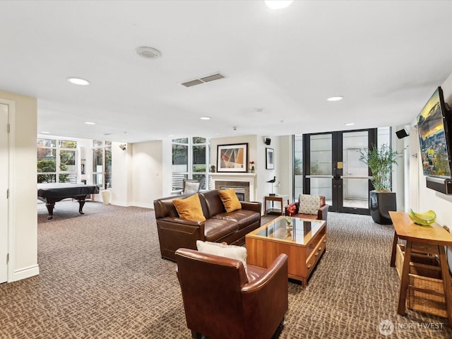 living area featuring visible vents, carpet floors, pool table, french doors, and a glass covered fireplace