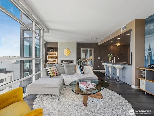 1420 Terry Ave Unit 901, Seattle, WA 98101 - living area with visible vents, wood finished floors, and baseboards