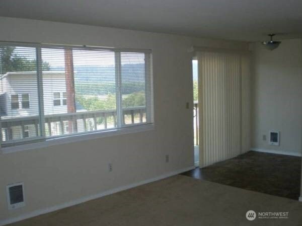 unfurnished room with visible vents