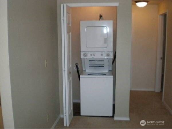 laundry room featuring stacked washing maching and dryer