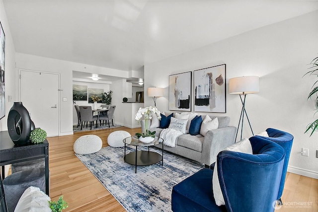 living room featuring baseboards and wood finished floors