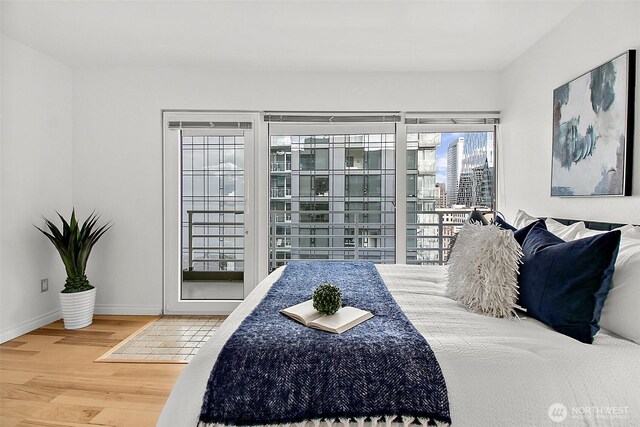 bedroom featuring baseboards and wood finished floors