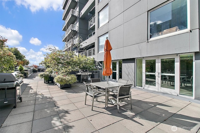 view of patio featuring outdoor dining space and a grill