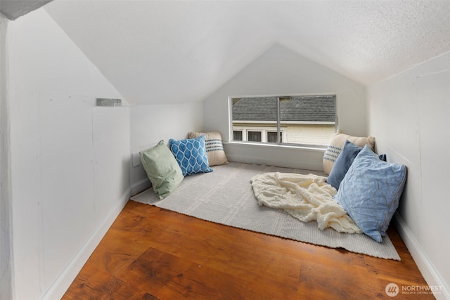 bedroom featuring vaulted ceiling and wood finished floors