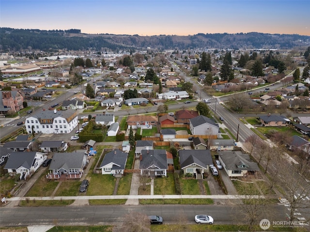 aerial view at dusk featuring a residential view