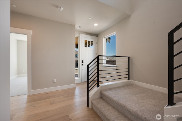 stairs with recessed lighting, wood finished floors, visible vents, and baseboards