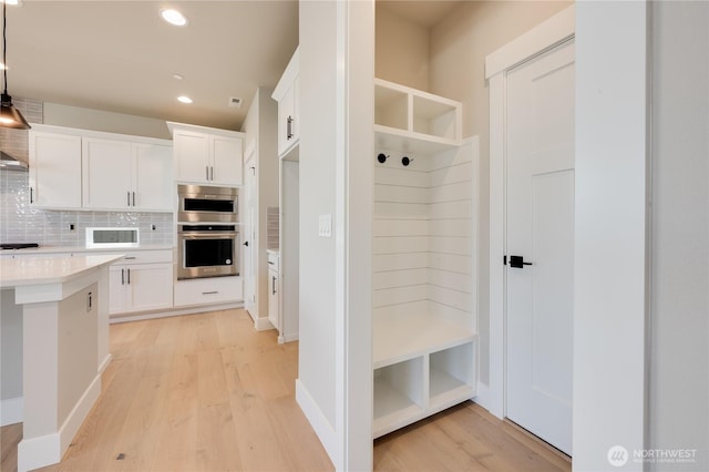 mudroom featuring light wood-style floors and recessed lighting