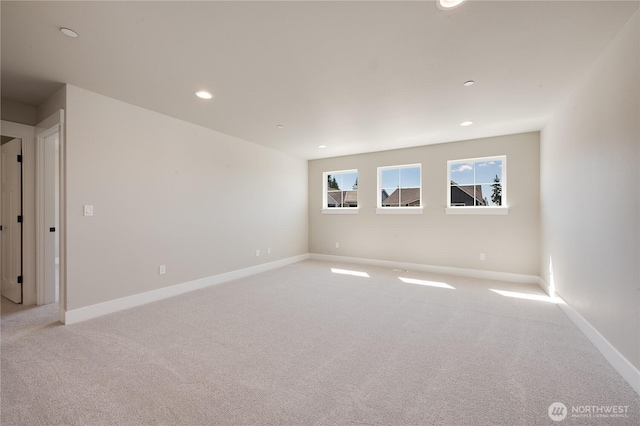 empty room with recessed lighting, carpet flooring, and baseboards