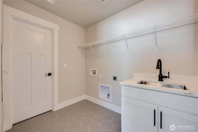 washroom featuring hookup for a washing machine, cabinet space, hookup for an electric dryer, a sink, and baseboards