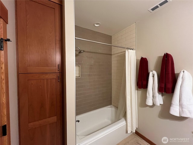 full bathroom with shower / bath combination with curtain, visible vents, and baseboards