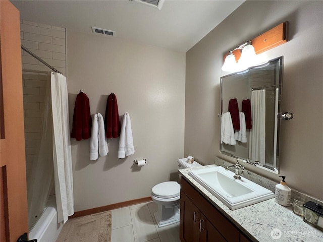 bathroom featuring toilet, vanity, visible vents, baseboards, and tile patterned floors