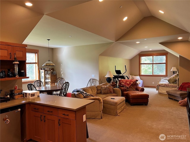 interior space featuring open floor plan, a peninsula, plenty of natural light, and pendant lighting