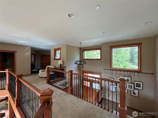 hallway featuring baseboards, carpet floors, an upstairs landing, and recessed lighting