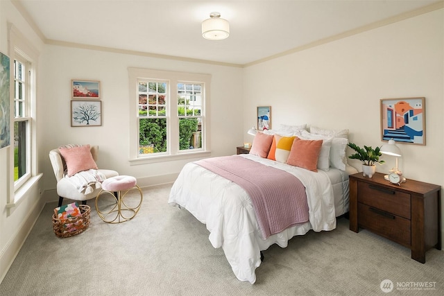 carpeted bedroom featuring baseboards and crown molding