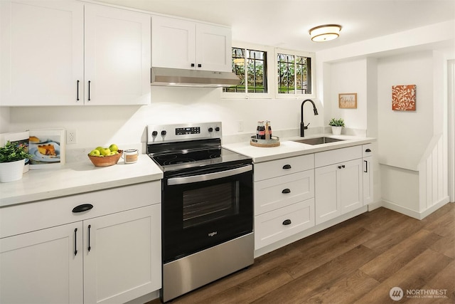 kitchen with under cabinet range hood, a sink, white cabinetry, stainless steel range with electric cooktop, and light countertops