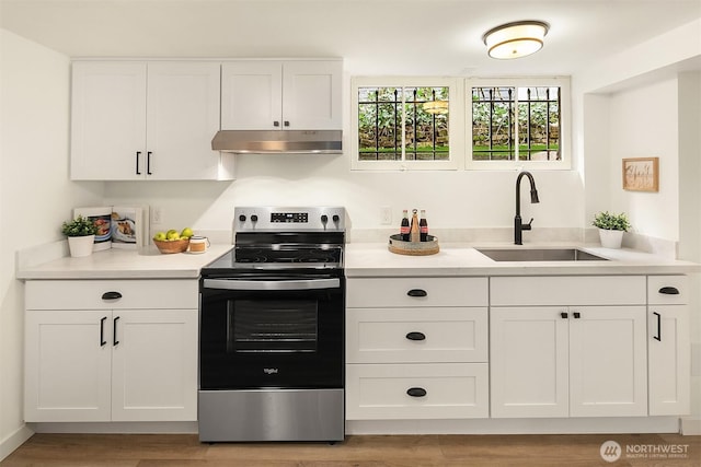 kitchen featuring white cabinetry, stainless steel electric range, under cabinet range hood, and a sink