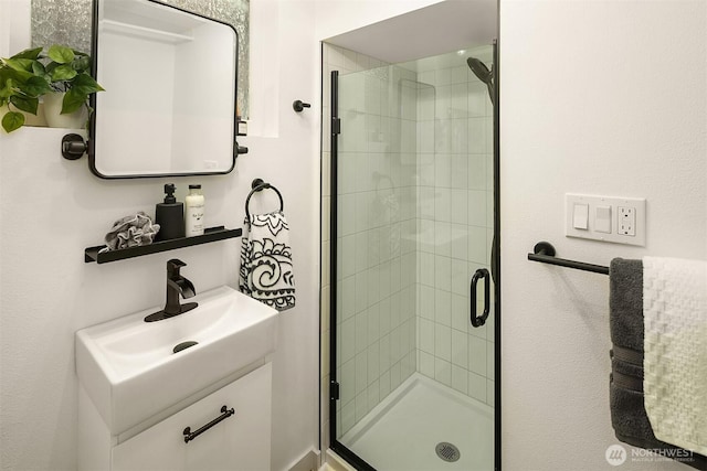 bathroom featuring a stall shower and vanity