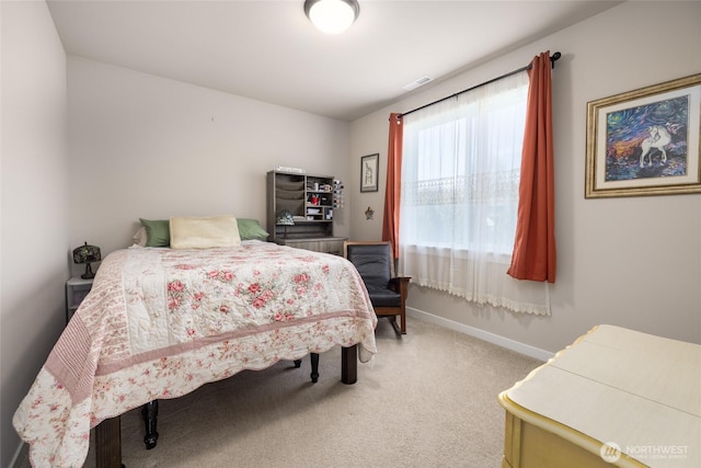 carpeted bedroom featuring visible vents and baseboards