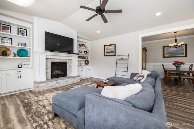 living area featuring lofted ceiling, built in shelves, and wood finished floors