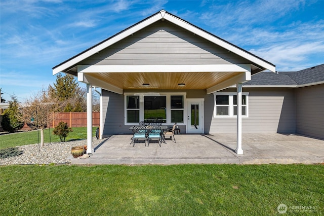 back of house featuring a patio, a lawn, and fence