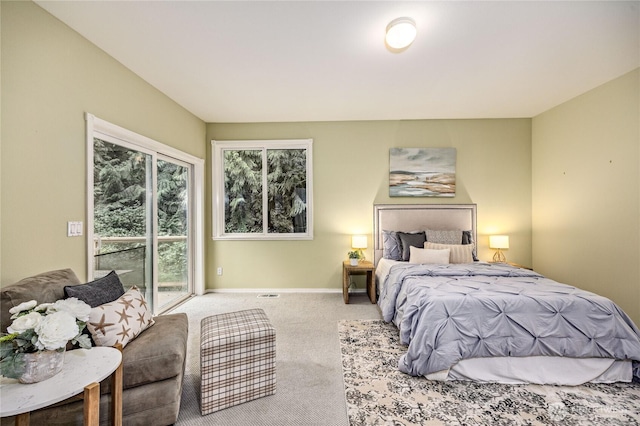 bedroom with access to outside, carpet flooring, and baseboards