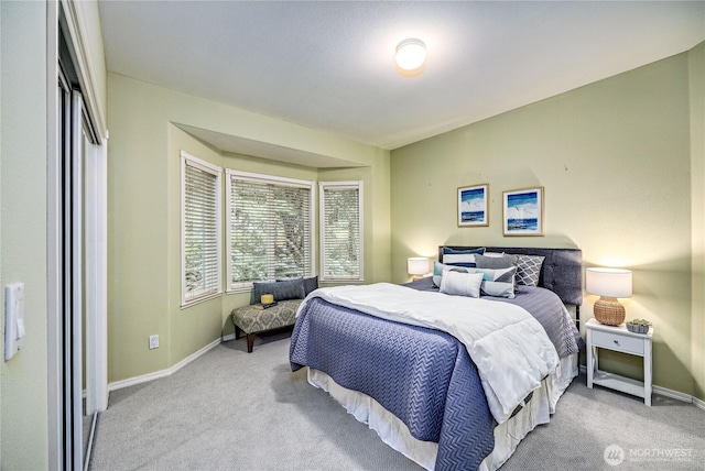 bedroom featuring carpet and baseboards