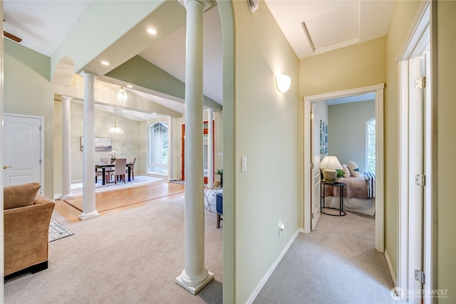 corridor with light carpet, ornate columns, and plenty of natural light