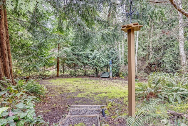 view of yard with a view of trees