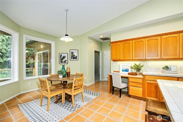 dining space with visible vents, built in study area, baseboards, and light tile patterned floors