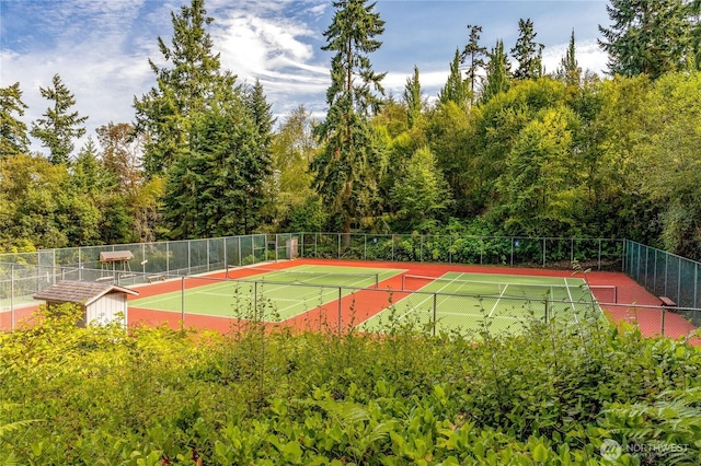 view of sport court featuring fence