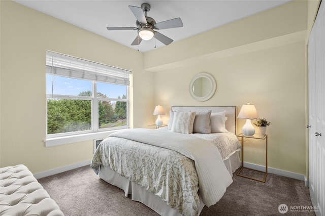 carpeted bedroom with a ceiling fan and baseboards