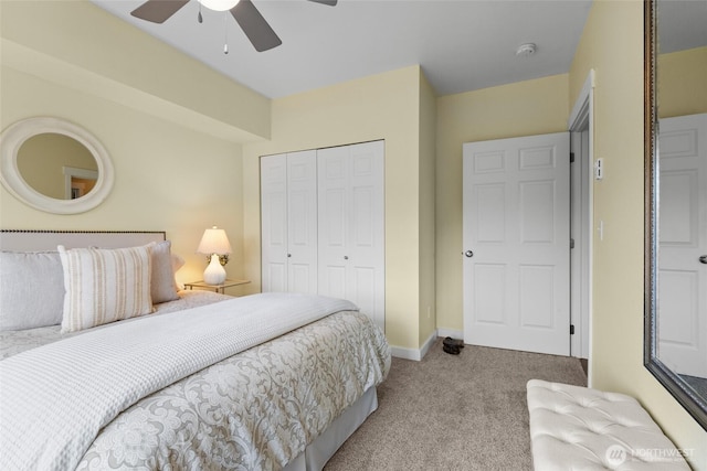 carpeted bedroom featuring a closet, ceiling fan, and baseboards