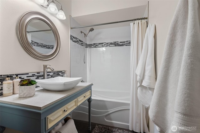 bathroom with shower / bath combo, vanity, and decorative backsplash