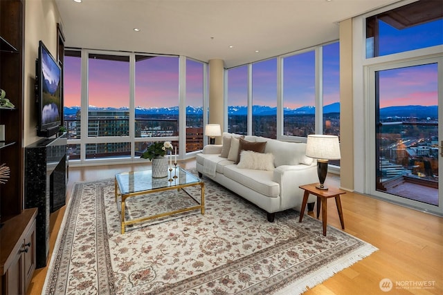 living room with expansive windows and wood finished floors