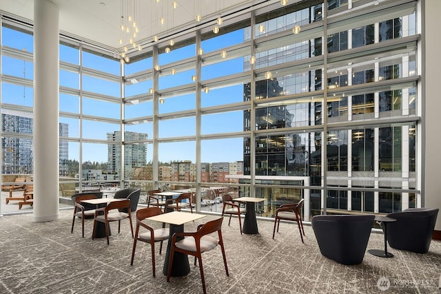 sunroom / solarium featuring a city view