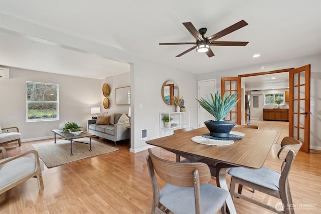 dining area featuring ceiling fan, recessed lighting, baseboards, light wood-type flooring, and a wall mounted air conditioner