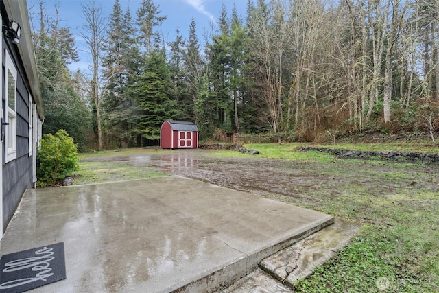 exterior space with a patio area, a storage unit, and an outdoor structure