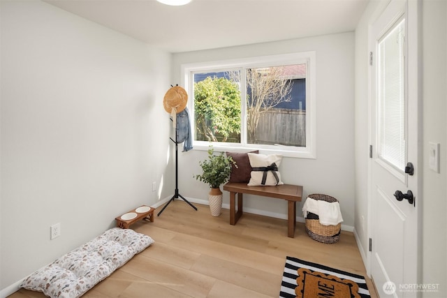 interior space with wood finished floors and baseboards