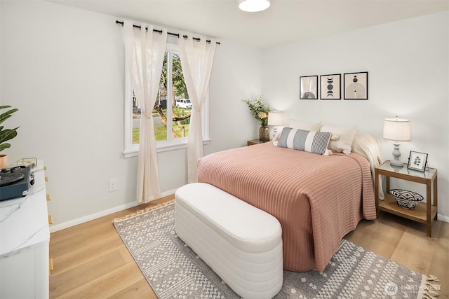 bedroom featuring baseboards and wood finished floors