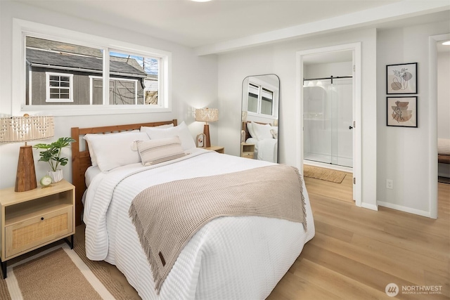 bedroom with baseboards and wood finished floors