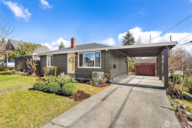 bungalow-style home with concrete driveway, a chimney, roof with shingles, a carport, and a front yard