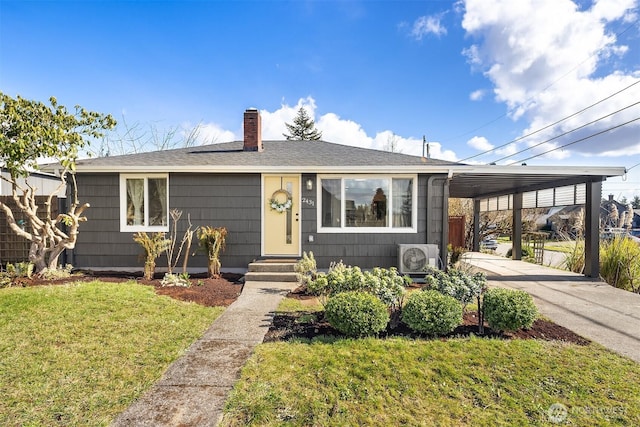 view of front facade featuring driveway, a shingled roof, a chimney, an attached carport, and a front yard