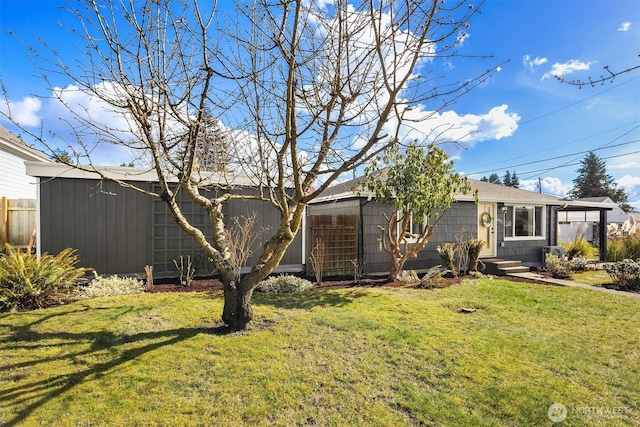 exterior space featuring a yard, an outbuilding, and fence