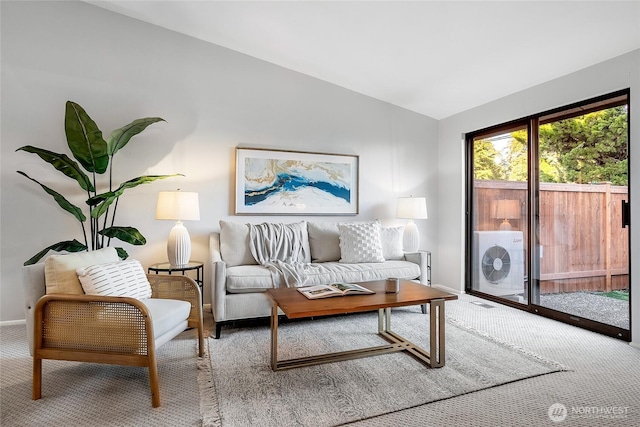 carpeted living room featuring baseboards and lofted ceiling