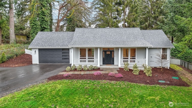 single story home with aphalt driveway, a porch, a shingled roof, an attached garage, and fence