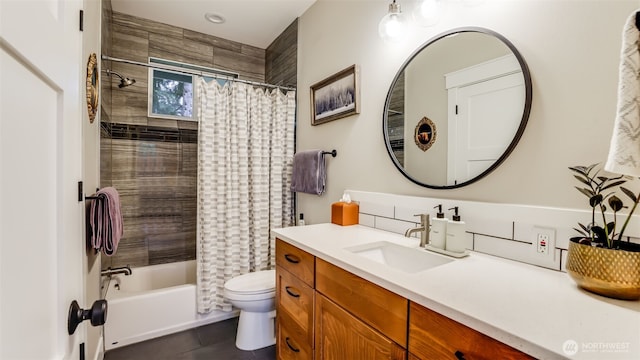 bathroom featuring shower / bath combo with shower curtain, vanity, toilet, and tile patterned floors